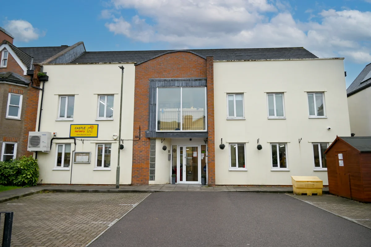 Castle Nursery building with outdoor parking.