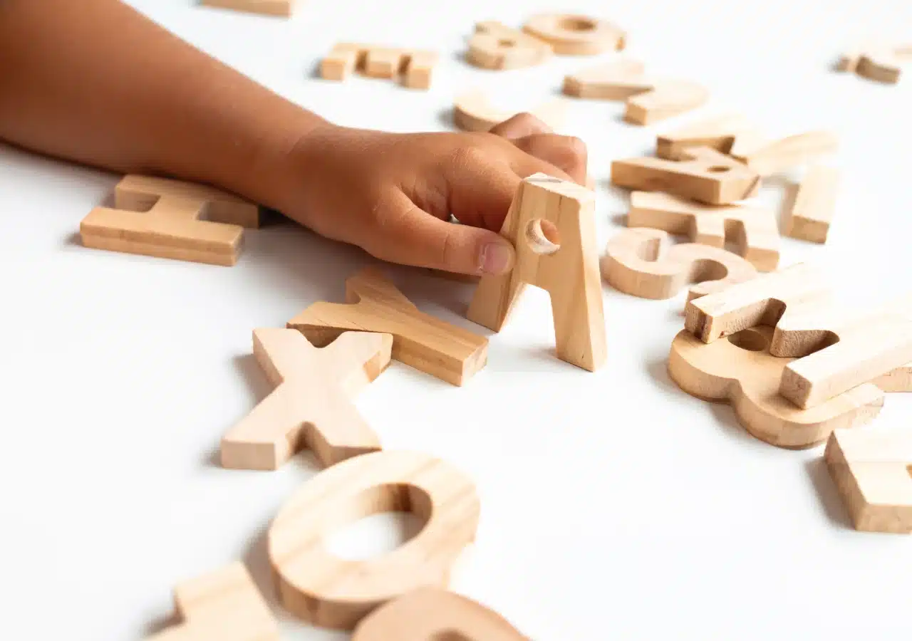 Child arranging letters.